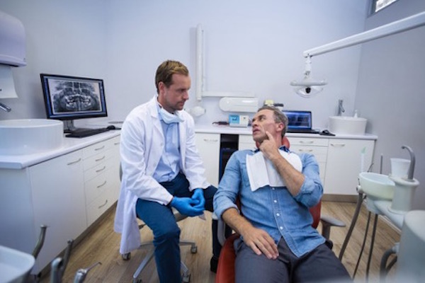 Image of Patient Consulting with Dentist Before the Surgery - ProDentures, Houston TX